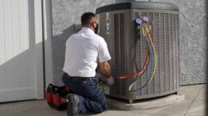 A friendly Service Champions technician in uniform expertly checks an AC unit in Rancho Santa Margarita, ensuring local home comfort.