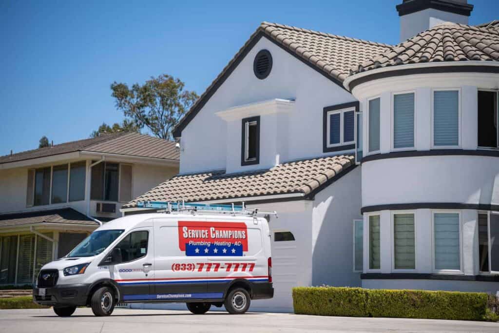A Service Champions van parked at a sunny, modern home, underscoring trusted energy-efficient comfort for Southern California families.