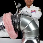 A caring technician in uniform expertly installs a metal air duct, using Service Champions’ trusted 13-Step Process for your comfort.