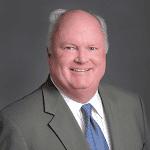 Professional man in business suit smiling for direct marketing campaign image.