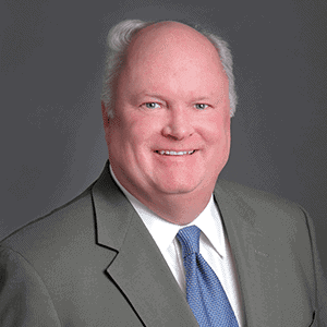 Professional man in business suit smiling for direct marketing campaign image.