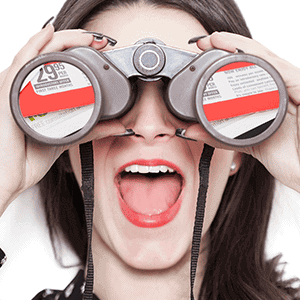 Close-up of woman using binoculars, representing marketing insight and strategic mail campaigns.