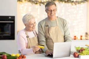 Credit card and laptop for direct mail marketing campaign in a modern kitchen.