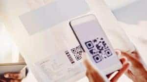 Scan QR code on direct mail piece with smartphone for innovative marketing outreach.