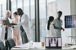 Professional healthcare team discussing medical images in a modern hospital setting.