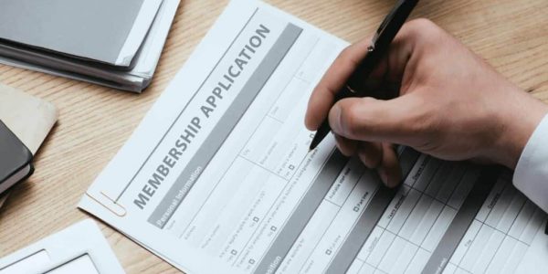 cropped view of man filling in Membership Application Form Register Concept