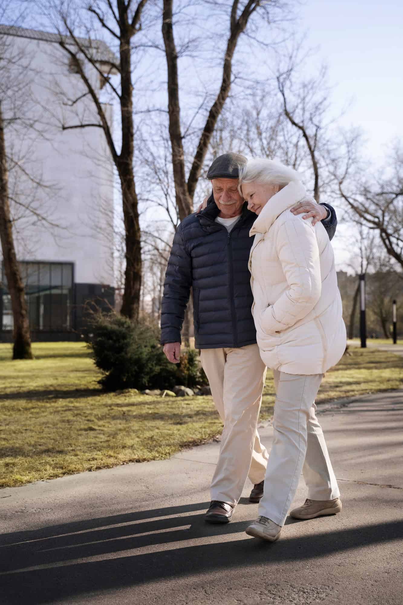 elderly couple walking on a sidewalk