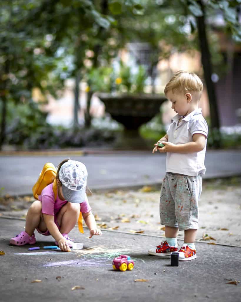 kids playing with chalk on the driveway to demonstrate peace of mind with our warranty
