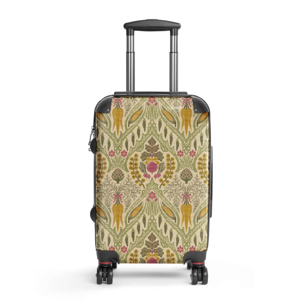 Close-up of Heirloom & Bloom floral and harvest print on hard-shell suitcase, showing wheat, gourds, and wildflowers.