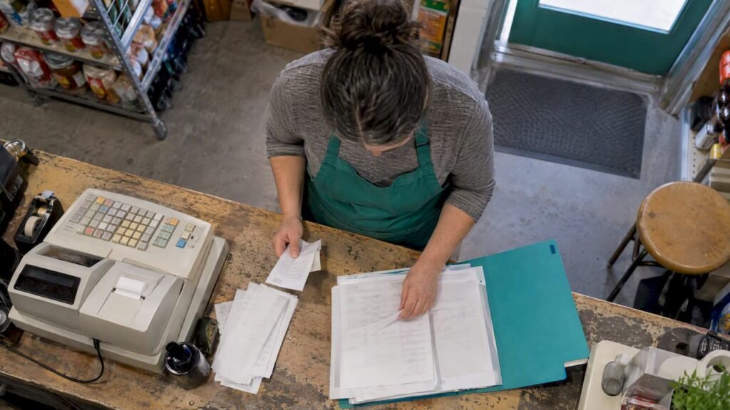 Business owner reconciling bank deposits