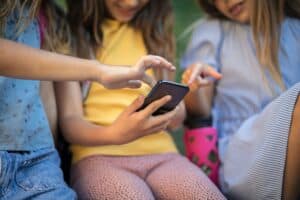 three girls using smart phone