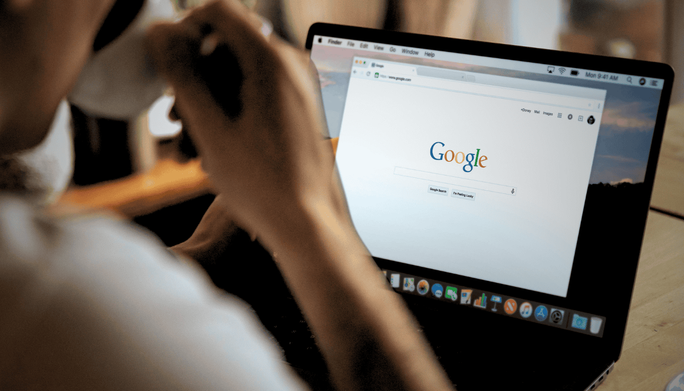 A person using an AI chat interface on a laptop, illustrating Google's move to allow users to import ChatGPT history into Gemini as competition between AI assistants intensifies.