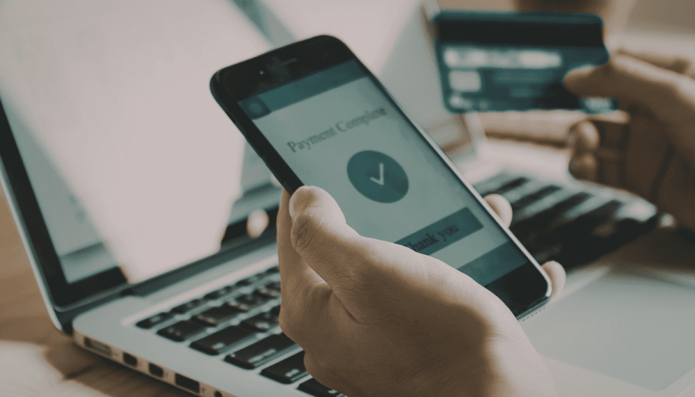 A person using a mobile banking app on a smartphone, representing the Lloyds Bank API glitch that exposed sensitive financial data for 448,000 customers following a routine software update.