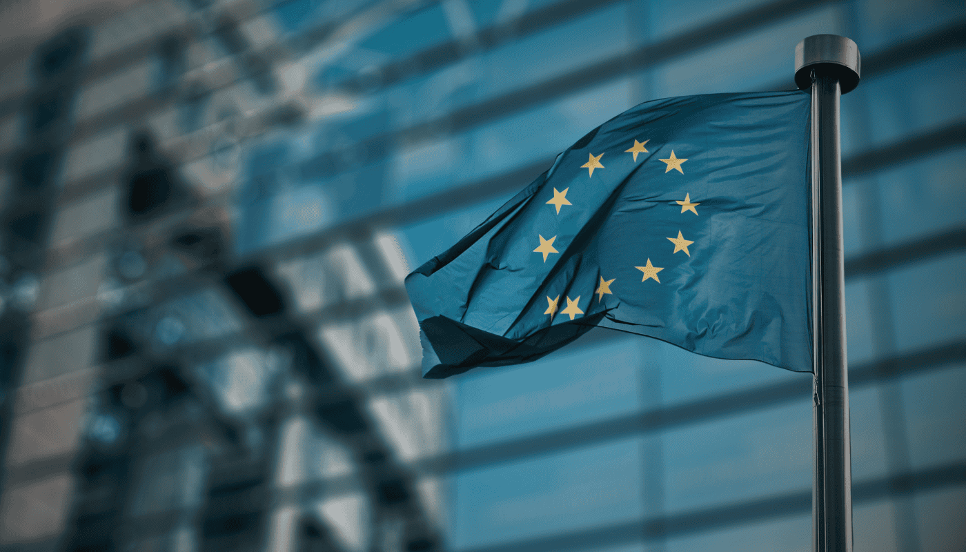 A European financial district at dusk, representing the debate over whether Europe's regulatory-first approach to AI in finance is protecting the continent or holding it back in the global AI race.