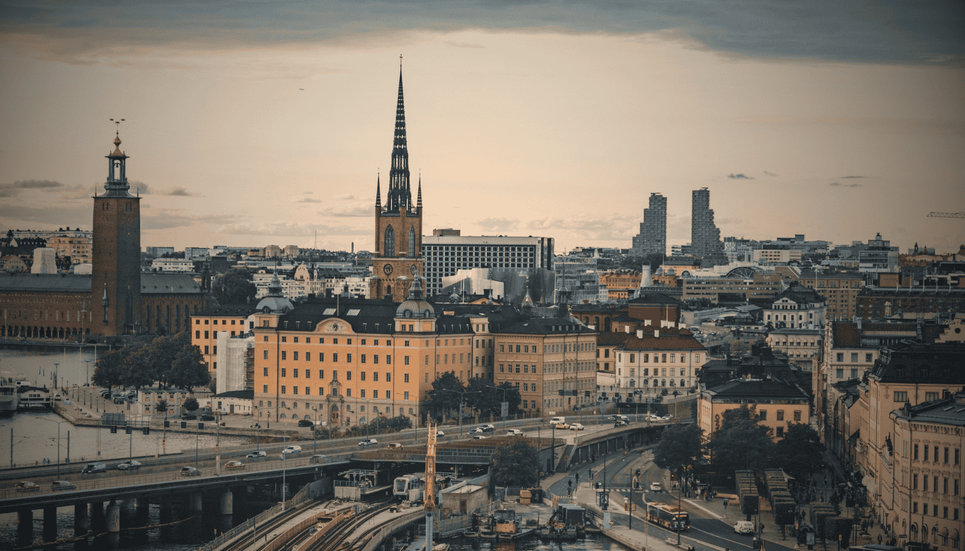 An aerial view of Stockholm, Sweden at dusk with city lights reflecting on the water, representing the country's thriving technology and SaaS startup scene.