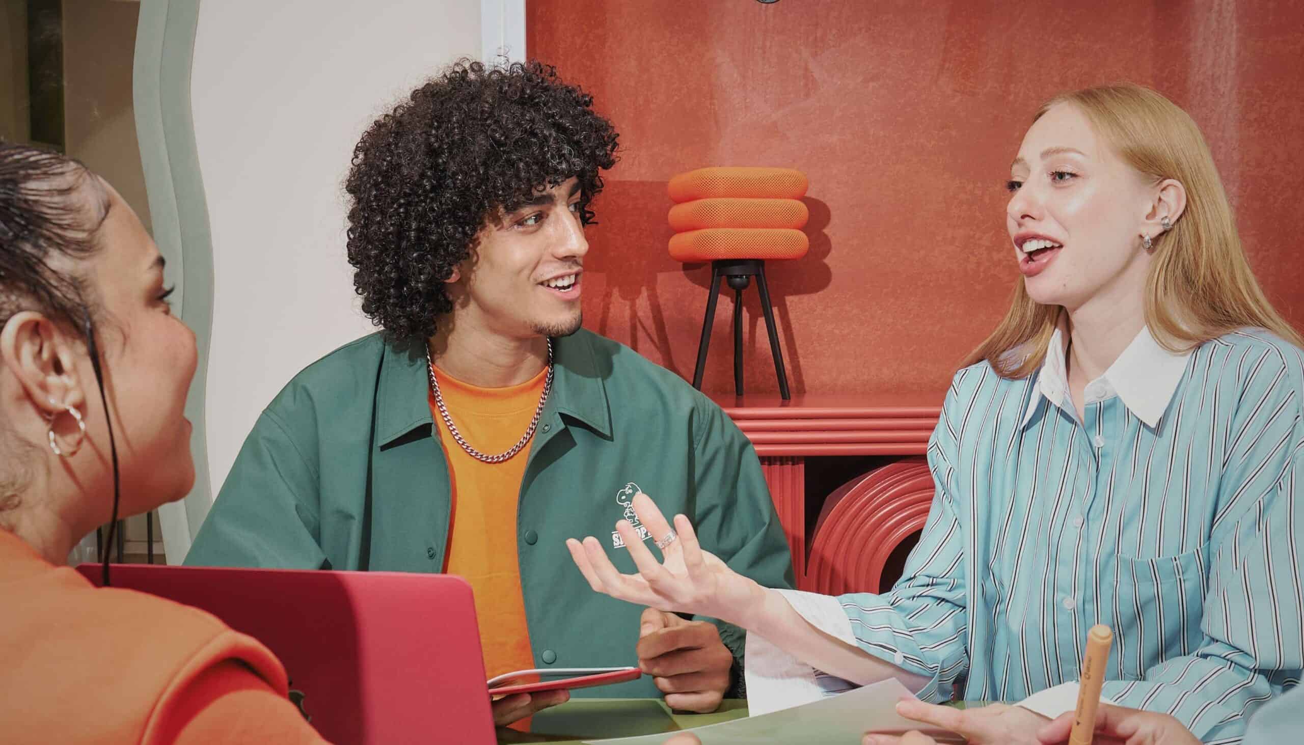 A diverse group of young professionals collaborating in a modern startup office, representing the growing trend of Gen Z workers choosing SMEs and startups over large technology companies.