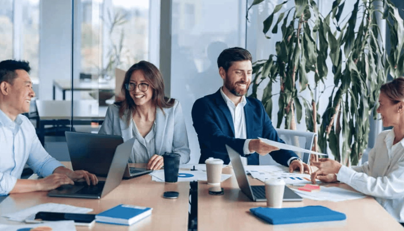 A mid-career professionals working at a laptop in a bright office, representing new data showing the average UK founder age has remained at 43 for over 25 years despite major economic disruption.