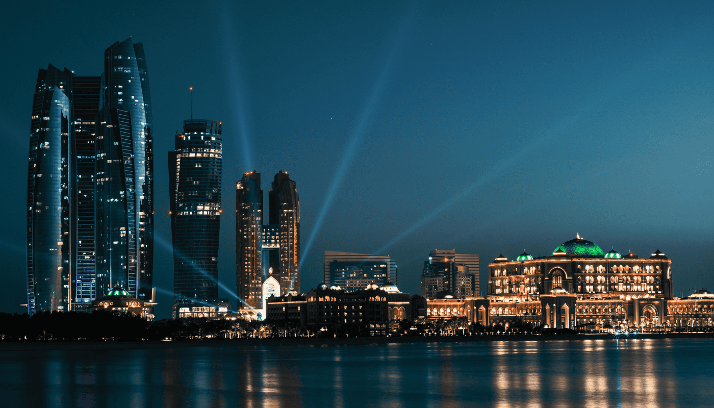 The Abu Dhabi skyline at dusk representing the Gulf region's investment in AI education and talent development, with institutions like MBZUAI training graduates specifically for the regional AI economy.