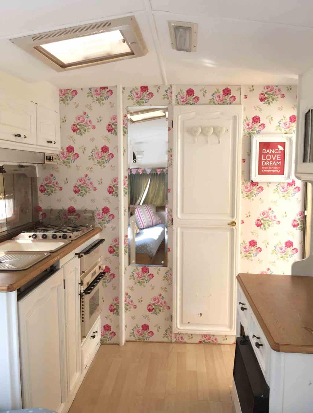 The living space in Dolly after her caravan makeover! I painted the ceiling and cupboards, and wallpapered the walls with Cath Kidston wallpaper. More info on both of my caravan makeovers on the blog!