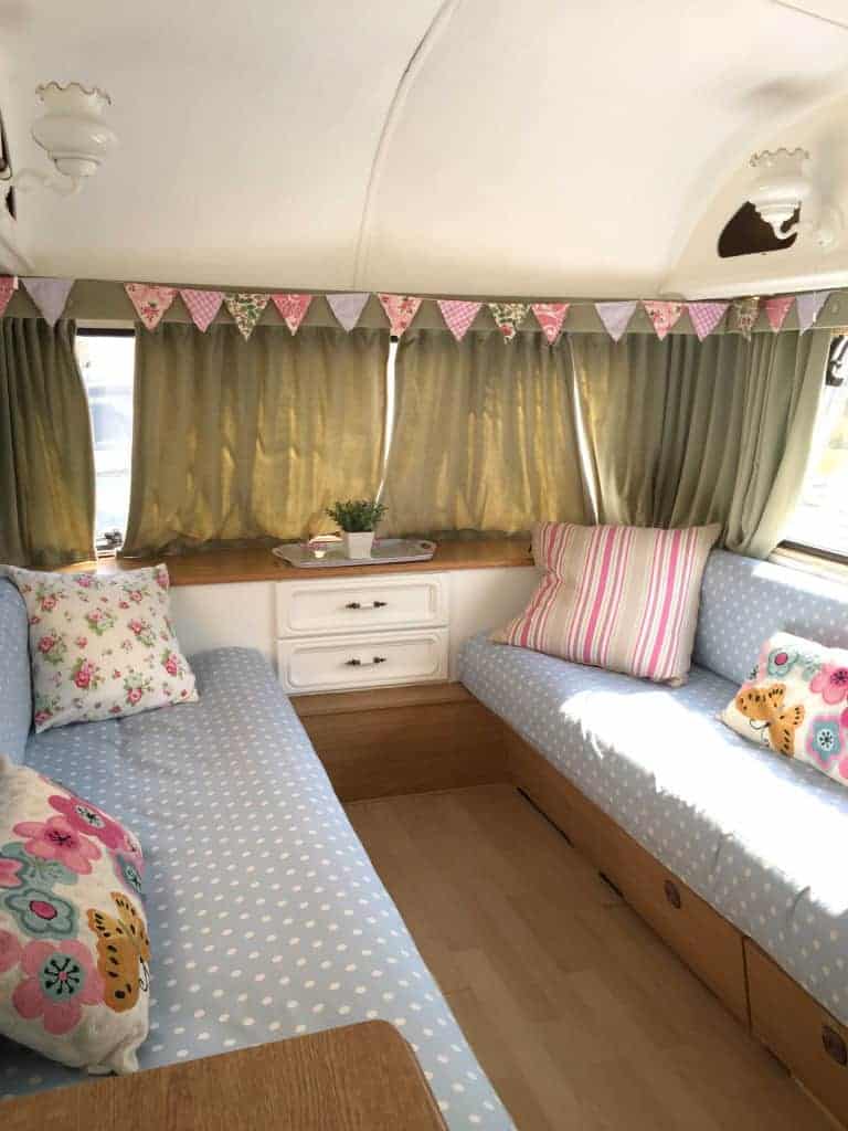 The interior of Dolly the caravan, after she had been painted as part of my first caravan makeover. I covered the seats in polkadot fabric and made shabby chic bunting. More info on both of my caravan makeovers on the blog!