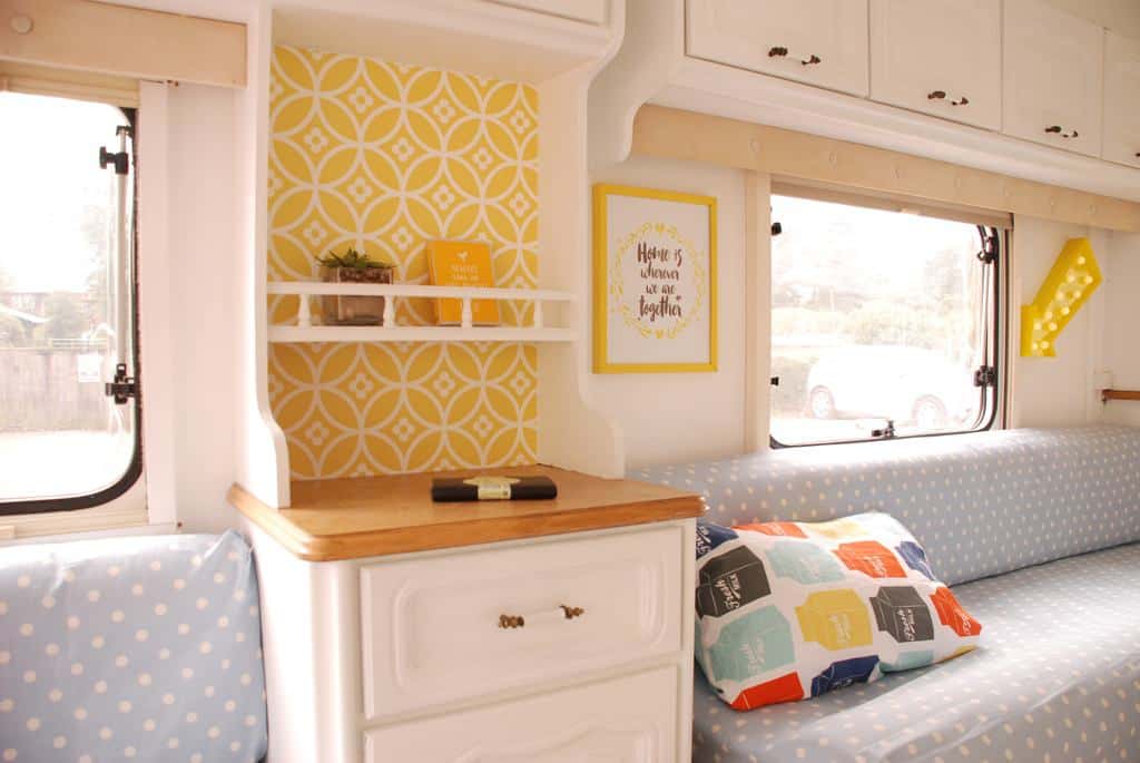 Caravan Renovation Project: After we'd carried out our restoration. Dolly looks fresh and bright with yellow wallpaper and white cabinetry in the lounge area.