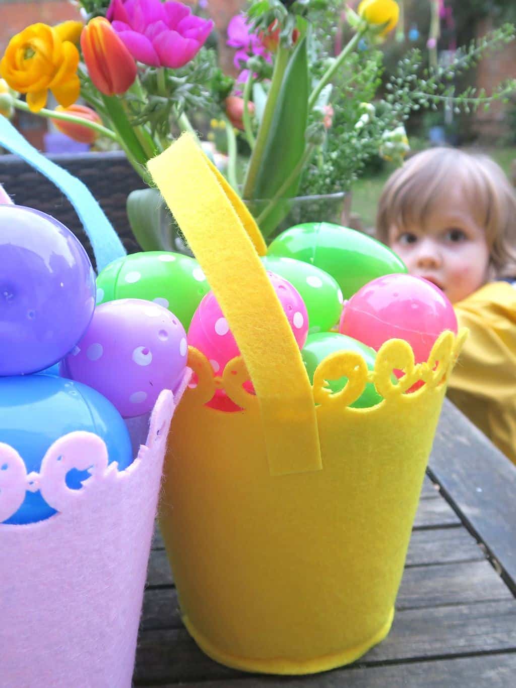 Colourful plastic eggs, ready for the perfect Easter egg hunt for toddlers.