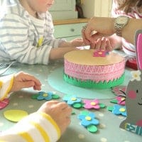 Family making Easter bonnets at the kitchen table