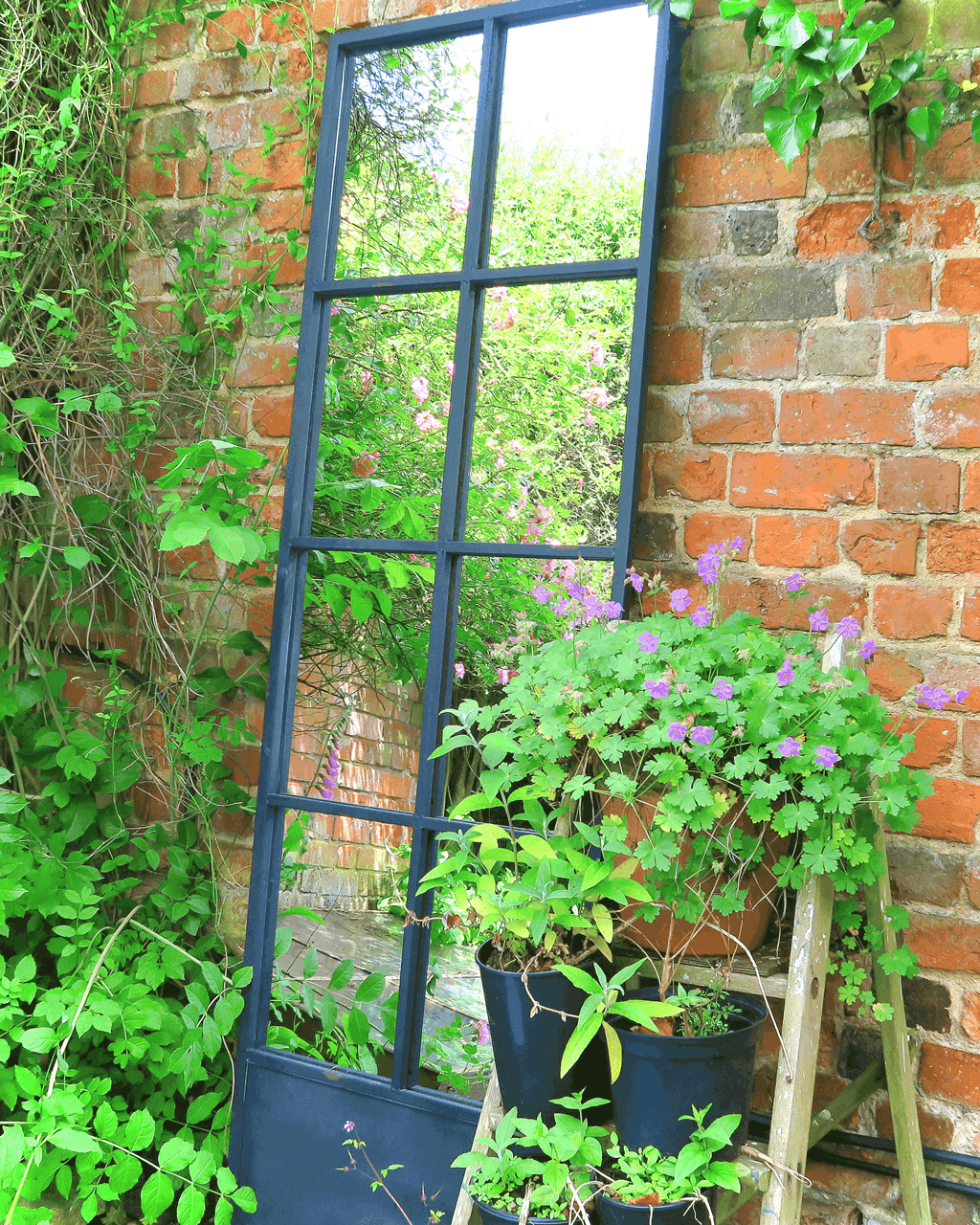 A strategically placed garden mirror will illuminate even the gloomiest corner and also give tantalising glimpses into other areas. This window pane mirror offers lots of different views. 