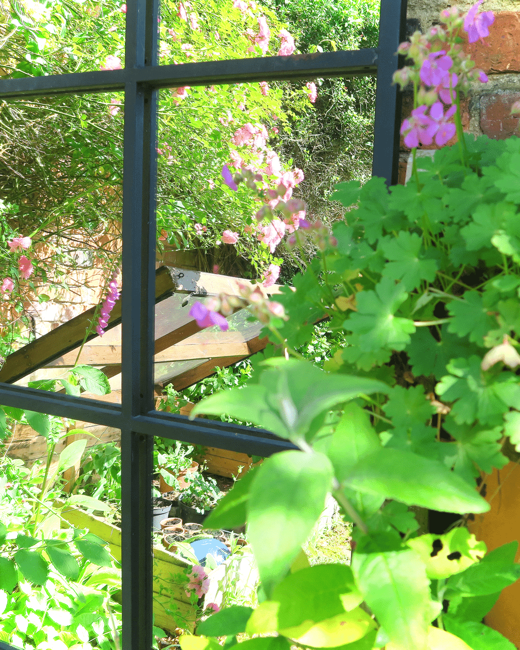 A strategically placed garden mirror will illuminate even the gloomiest corner and also give tantalising glimpses into other areas.