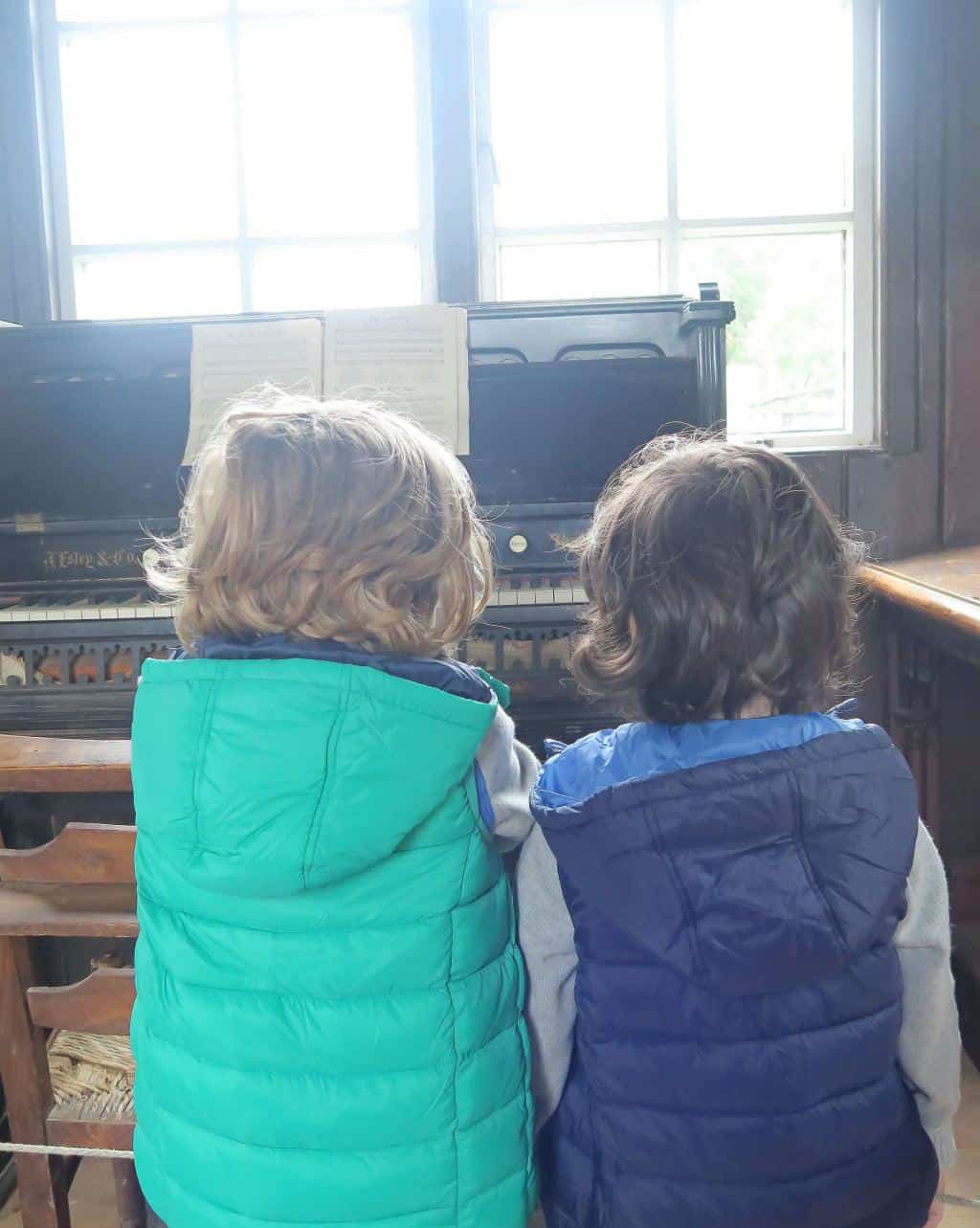 Bertie and Cosmo getting to grips with the organ at the Chiltern Open Air Museum