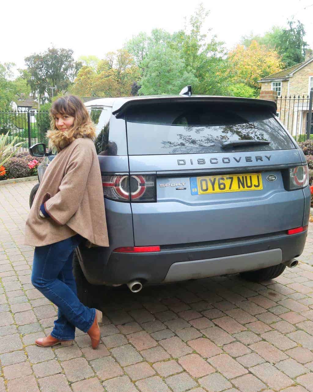 Caro standing by the  Discovery Sport HSE LUX