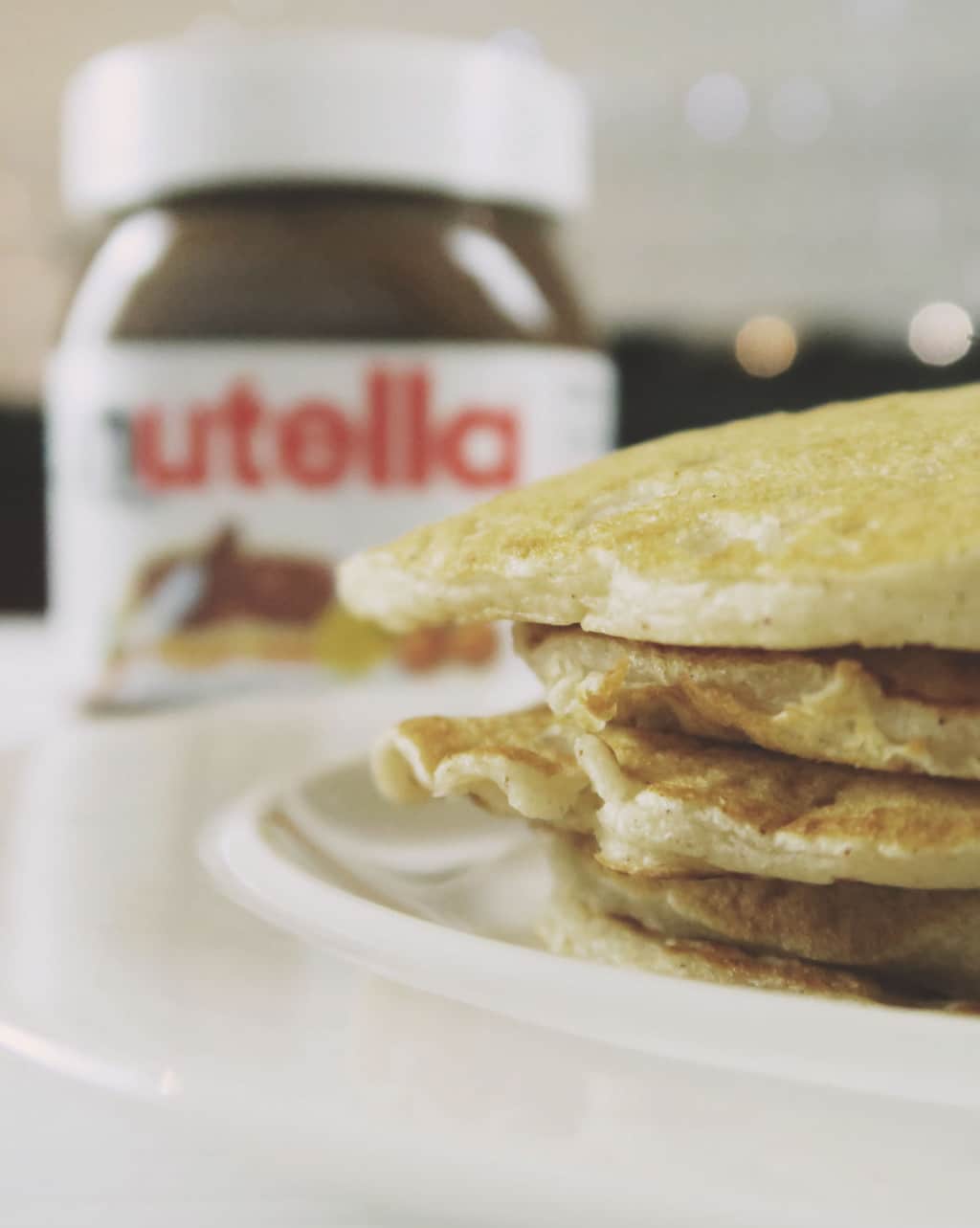 The Best Eggless Pancake Recipe EVER {Featuring Nutella} — stack of pancakes with Nutella