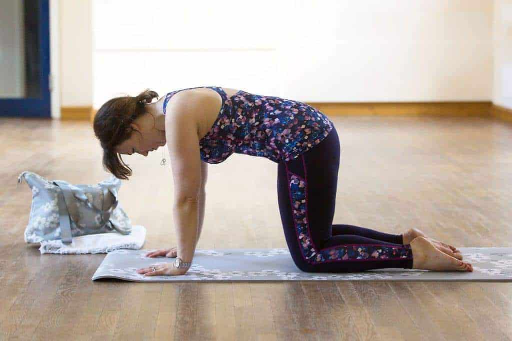 My Favourite 5 Pilates Exercises — Pilates cat stretch position 2 — Starting with your tailbone, start to tip your pelvis forward.  Pull your navel in towards your spine and squeeze your bottom to try to create a rounded C shape with your lower back.