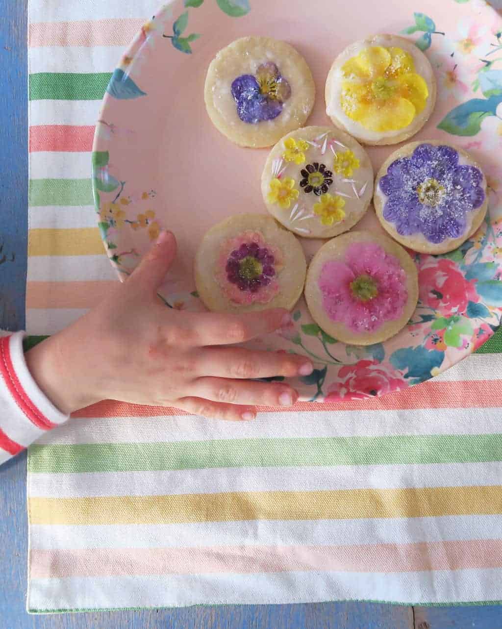 Edible flower biscuits on a floral melamine plate
