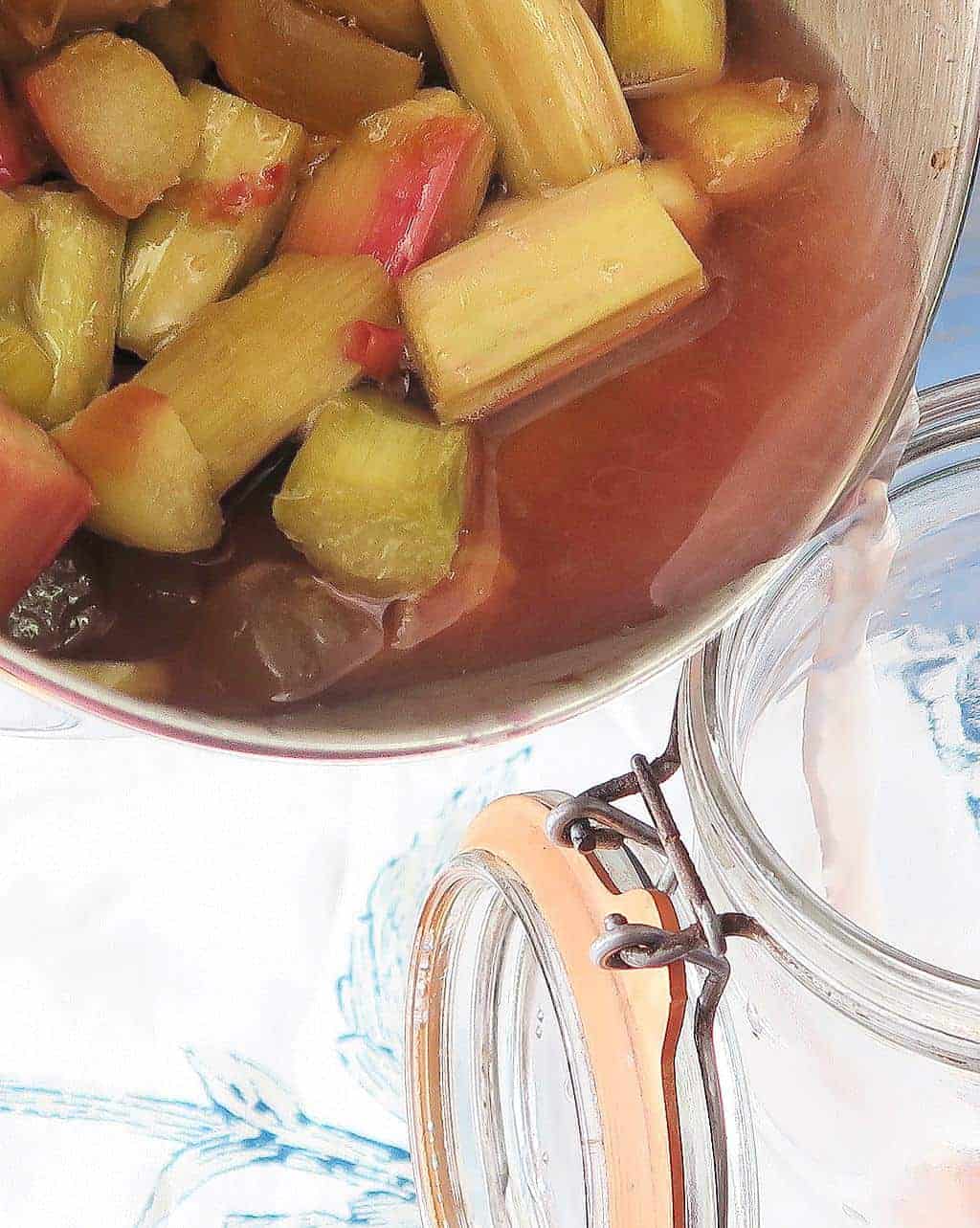 pouring homemade ginger and rhubarb gin into a jar