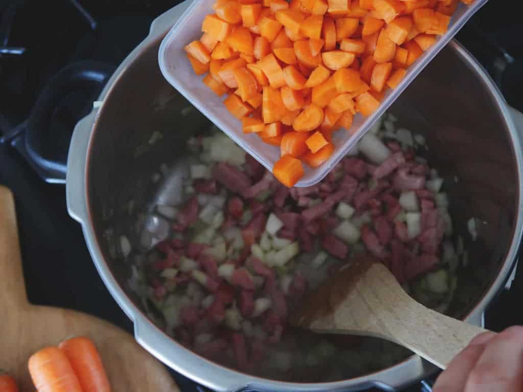 Step two of our quick and easy 15 minute pressure cooker lentil and bacon soup recipe.