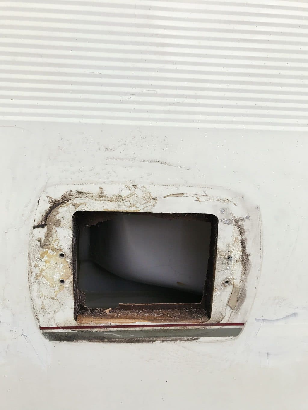 Removing vent covers makes it easier to paint a caravan exterior