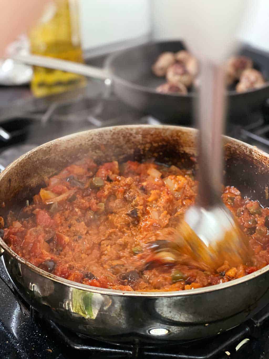 A recipe for homemade Italian Pasta Puttanesca with meatballs.