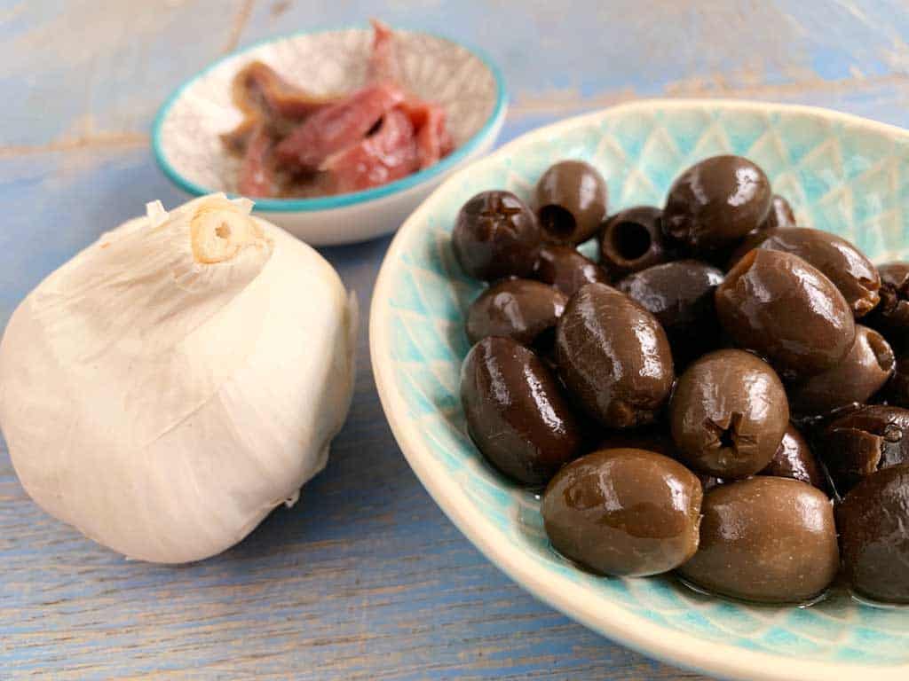 A recipe for homemade Italian Pasta Puttanesca with meatballs.