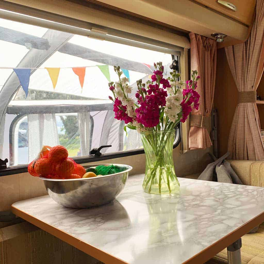 You can see OLPRO View 420 Caravan Inflatable Porch Awning through the window — it's doubled the living space of the caravan