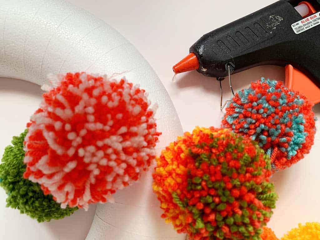 Want to learn how to make a pom pom wreath? This is such a fun project!