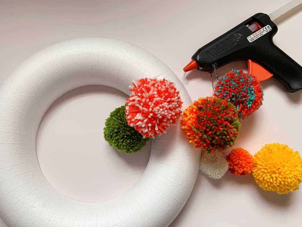 Want to learn how to make a pom pom wreath? This is such a fun project!