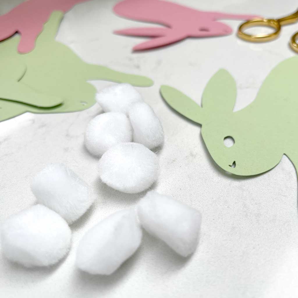 Create an easter bunny garland with craft pom poms and card.
