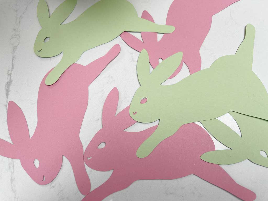 Cut the Free Bunny PNG File out of coloured card to create an easter garland.