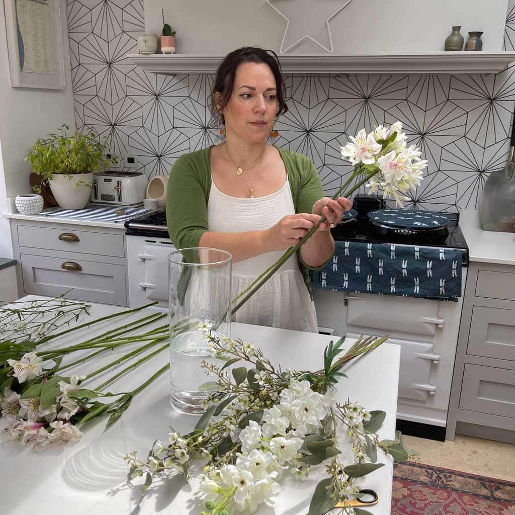 Faux flowers that look real mixed with fresh flowers are a great way of creating large, inexpensive, floral arrangements 