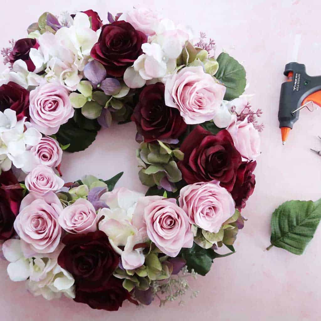 Cheap home decor ideas - add faux flowers to an old wreath to create new seasonal decor.