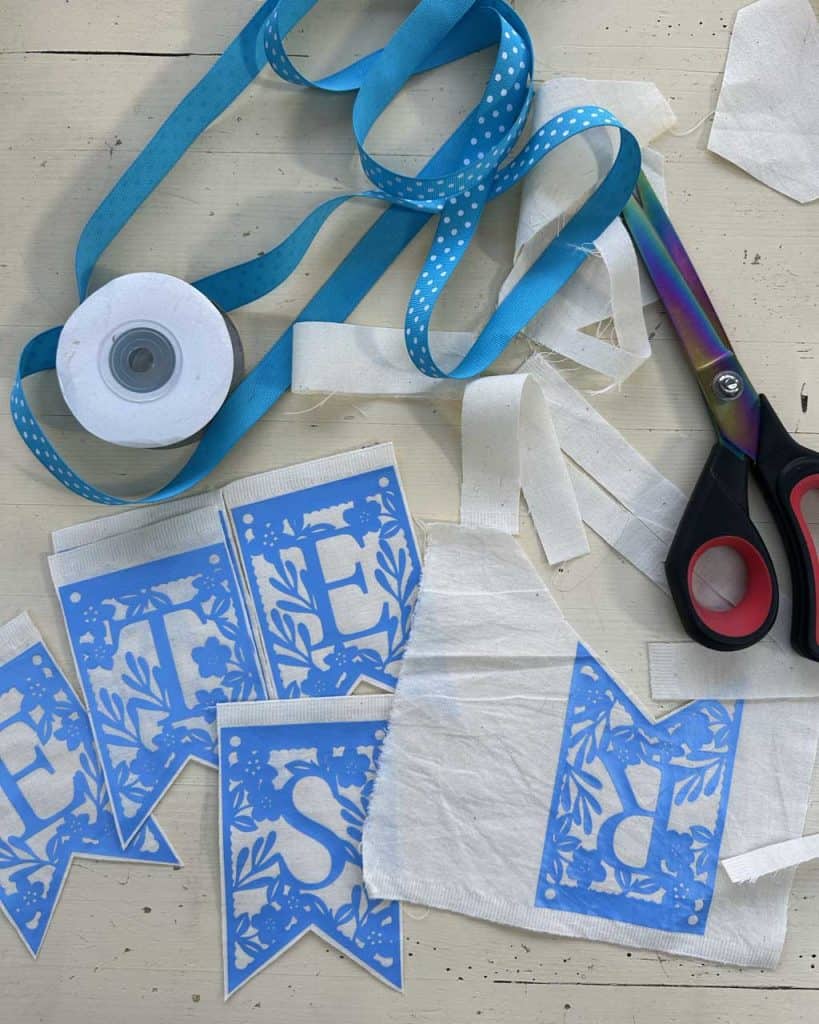 Easter banner pieces ready to sew onto the ribbon heading.