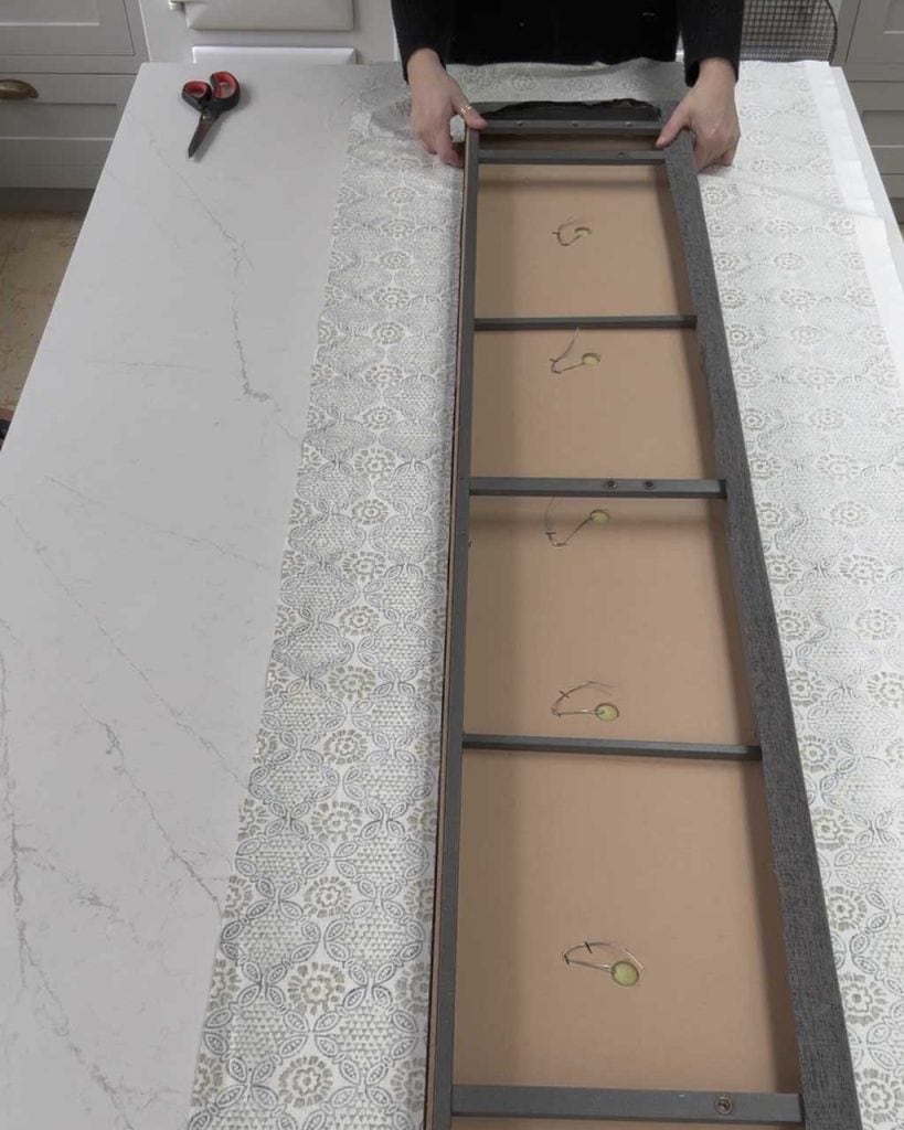6. How to Upholster a Headboard and Bedframe: Place the headboard — or a section of your bedframe — on top of the fabric. 