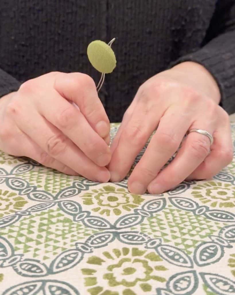 7. How to Upholster a Headboard: Adding covered buttons to the headboard.