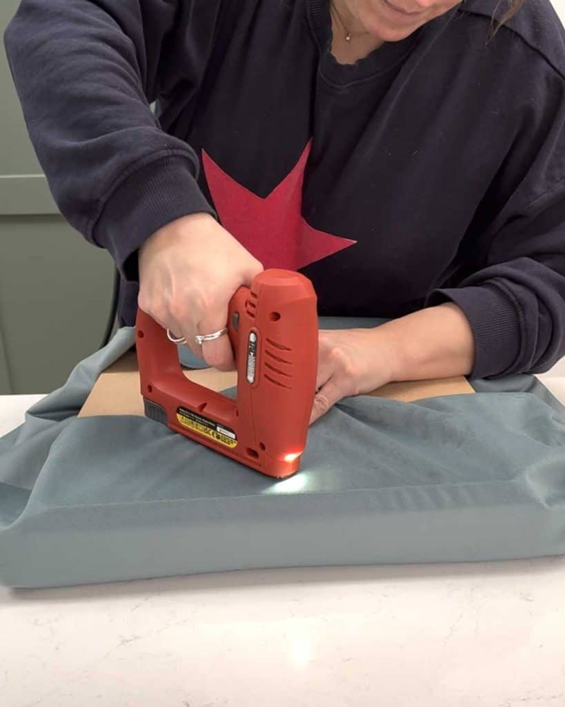 Rush Chair Seat Replacement DIY Tutorial — staple the fabric on to the base.